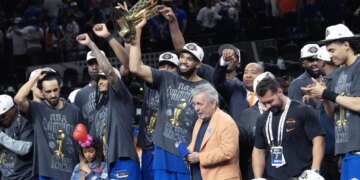 A jubilant Karl-Anthony Towns celebrates with owner James Dolan and his Knicks teammates after their 94-90 Game 5 NBA title-clinching win over the Spurs on June 13, 2026 in San Antonio.