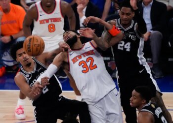 New York Knicks center Karl-Anthony Towns (32), San Antonio Spurs guard Dylan Harper (2) and guard Devin Vassell (24) battle for the ball during the first half of Game 3 of the NBA Finals basketball series, Monday, June 8, 2026, in New York.