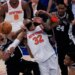 New York Knicks center Karl-Anthony Towns (32), San Antonio Spurs guard Dylan Harper (2) and guard Devin Vassell (24) battle for the ball during the first half of Game 3 of the NBA Finals basketball series, Monday, June 8, 2026, in New York.
