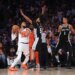 New York Knicks player Karl-Anthony Towns (#32) drives with the ball against San Antonio Spurs guard Stephon Castle (#5) and guard #1 in Game 3 of the 2026 NBA Finals.