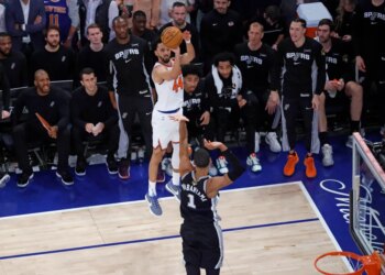 New York Knicks guard Landry Shamet (44) takes a three-point shot over San Antonio Spurs forward Victor Wembanyama (1) during the 2026 NBA Finals.