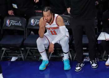 New York Knicks guard Jalen Brunson (11) reacts on the bench during the fourth quarter.
