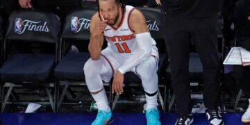New York Knicks guard Jalen Brunson (11) reacts on the bench during the fourth quarter.