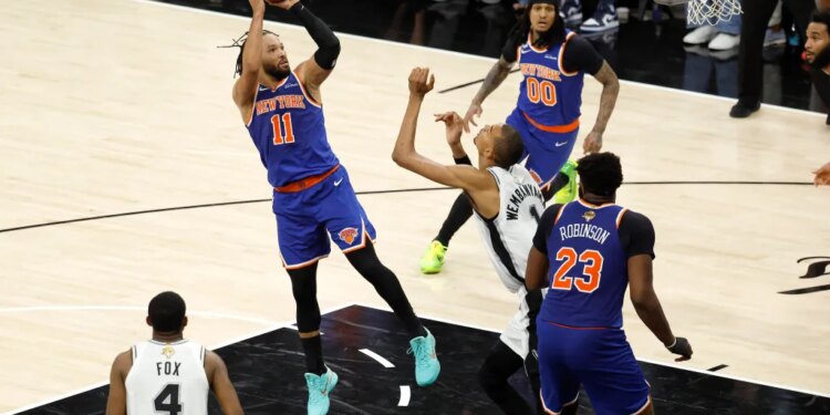 New York Knicks guard Jalen Brunson (11) shoots over San Antonio Spurs forward Victor Wembanyama (1) during Game 5 of the 2026 NBA Finals.