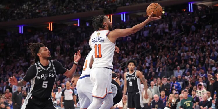 New York Knicks guard Jalen Brunson #11 goes up for a shot against San Antonio Spurs #5 during Game 3 of the 2026 NBA Finals.