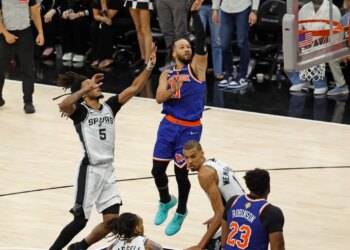 New York Knicks guard Jalen Brunson (11) goes up for a shot pass San Antonio Spurs guard Stephon Castle (5) during the fourth quarter of game 5 of the 2026 NBA Finals.

