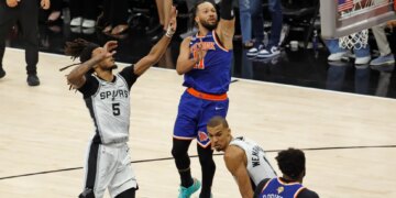 New York Knicks guard Jalen Brunson (11) goes up for a shot pass San Antonio Spurs guard Stephon Castle (5) during the fourth quarter of game 5 of the 2026 NBA Finals.

