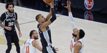 San Antonio Spurs forward Victor Wembanyama (1) puts up a shot over New York Knicks center Karl-Anthony Towns (32