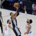 San Antonio Spurs forward Victor Wembanyama (1) puts up a shot over New York Knicks center Karl-Anthony Towns (32