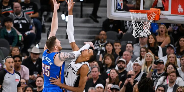 San Antonio Spurs forward Victor Wembanyama, right, blocks a shot by Oklahoma City Thunder center Isaiah Hartenstein during the second half of Game 4 in the Western Conference finals NBA basketball playoffs series in San Antonio, Sunday, May 24, 2026.