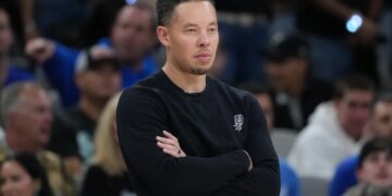 Mitch Johnson, head coach of the San Antonio Spurs, watching an NBA Finals game.
