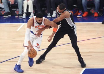 New York Knicks vs. San Antonio Spurs at Madison Square Garden - New York Knicks center Karl-Anthony Towns #32 drives down court as San Antonio Spurs forward Victor Wembanyama #1 defends during the first quarter.
