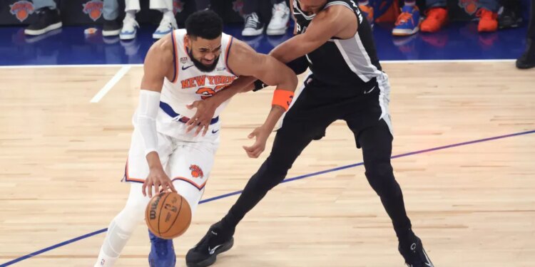 New York Knicks vs. San Antonio Spurs at Madison Square Garden - New York Knicks center Karl-Anthony Towns #32 drives down court as San Antonio Spurs forward Victor Wembanyama #1 defends during the first quarter.