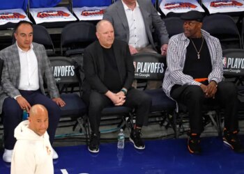 Gersson Rosas, Leon Rose, and Patrick Ewing watch warm-ups before Game 1 of the Eastern Conference Finals.