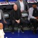 Gersson Rosas, Leon Rose, and Patrick Ewing watch warm-ups before Game 1 of the Eastern Conference Finals.