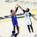 New York Knicks guard Jalen Brunson #11 hits a three-point shot over San Antonio Spurs forward Julian Champagnie #30 during the 1st half.
