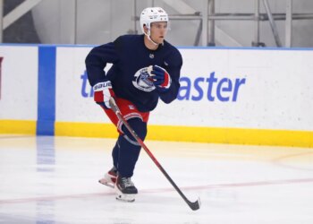 New York Rangers player Liam Greentree (85) skating on ice with a hockey stick during development camp.