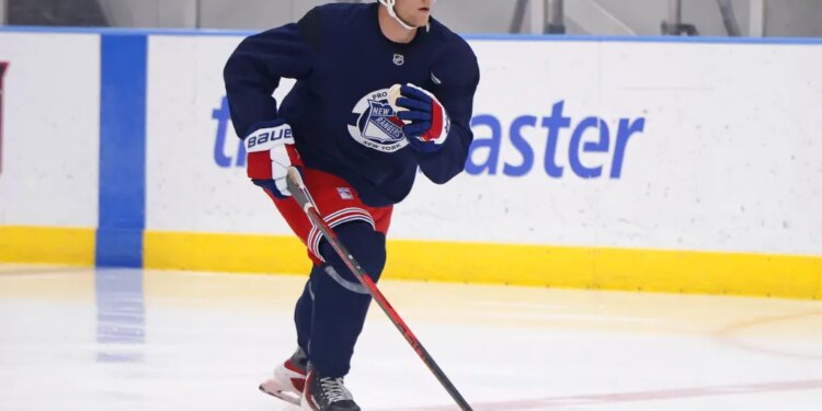 New York Rangers player Liam Greentree (85) skating on ice with a hockey stick during development camp.