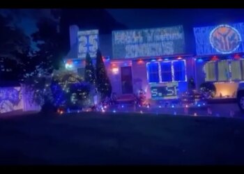 A Long Island house decorated with blue and orange lights and signs for the NBA finals.