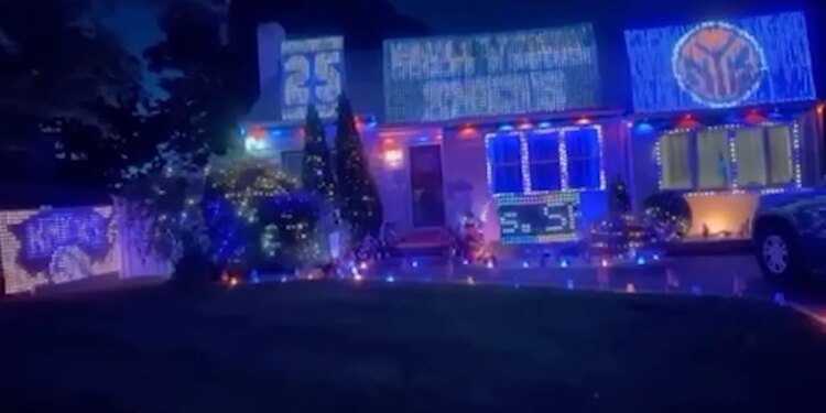 A Long Island house decorated with blue and orange lights and signs for the NBA finals.