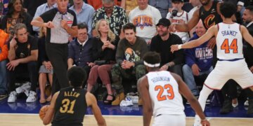 Actors Ben Stiller, Christine Taylor, Michael J. Fox, and Timothée Chalamet sit courtside at an NBA Eastern Conference Finals game.