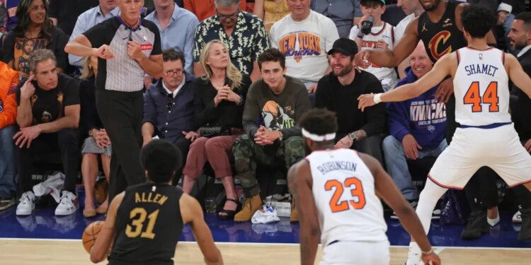 Actors Ben Stiller, Christine Taylor, Michael J. Fox, and Timothée Chalamet sit courtside at an NBA Eastern Conference Finals game.