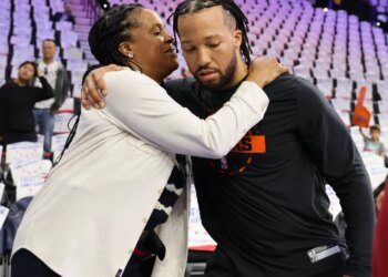 Jalen Brunson hugs his mother, Sandra Brunson, during warm-ups for an NBA Playoffs game.