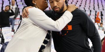 Jalen Brunson hugs his mother, Sandra Brunson, during warm-ups for an NBA Playoffs game.