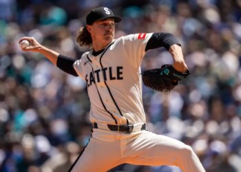 Seattle Mariners pitcher Bryce Miller in mid-delivery during a game.