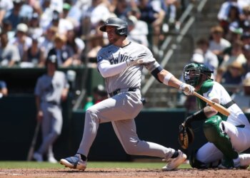 Max Schuemann swinging a baseball bat during a game.