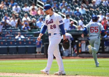 New York Mets pitcher Nolan McLean #26 reacts as he walks off the field after ending the sixth inning giving up a three-run home run.
