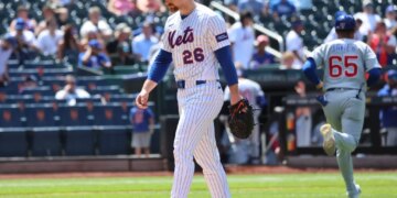 New York Mets pitcher Nolan McLean #26 reacts as he walks off the field after ending the sixth inning giving up a three-run home run.
