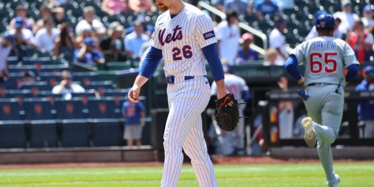 New York Mets pitcher Nolan McLean #26 reacts as he walks off the field after ending the sixth inning giving up a three-run home run.
