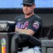 New York Mets manager Carlos Mendoza watching from the dugout.