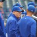 New York Mets owner Steve Cohen speaking with bench coach Kai Correa before a game.