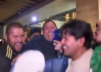 Fox Sports Mexico reporter Carlos Rodrigo Hernandez is lifted in the air by fans