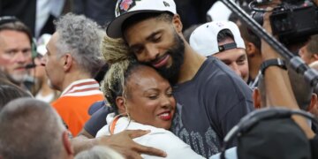 Mikal Bridges #25, getting a hug after the Knicks defeated the Spurs to win the NBA Championship.
