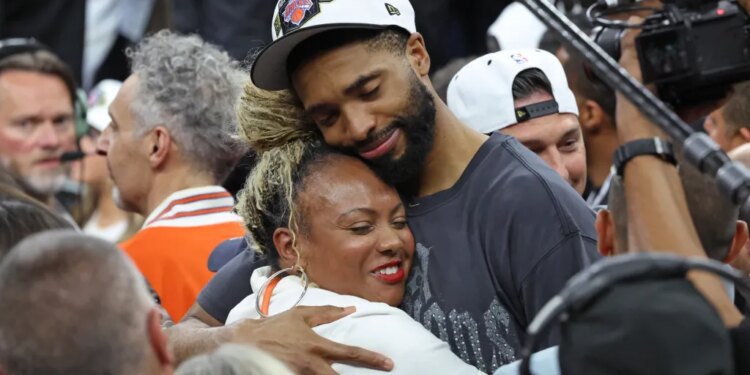 Mikal Bridges #25, getting a hug after the Knicks defeated the Spurs to win the NBA Championship.
