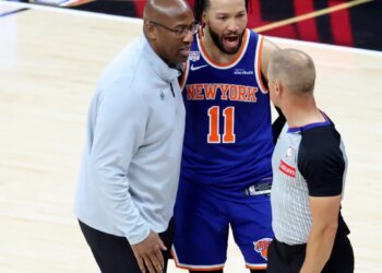 Knicks head coach Mike Brown (l.) and guard Jalen Brunson (11) talks to a referee during Game 5 of the NBA Finals against the Spurs on June 13, 2026.