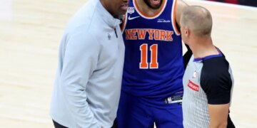 Knicks head coach Mike Brown (l.) and guard Jalen Brunson (11) talks to a referee during Game 5 of the NBA Finals against the Spurs on June 13, 2026.