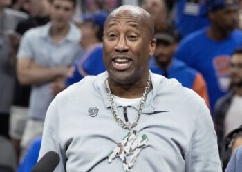 Head coach Mike Brown wears rapper Fat Joes’ chain as he addresses the crowd after the Knicks' 94-90 NBA title-clinching Game 5 win over the Spurs on July 13, 2026.