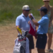 Miles Russell's dad, Joe, given the caddie bib ahead of the 18th hole at the U.S. Open on Sunday.