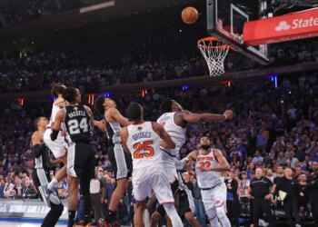 New York Knicks forward OG Anunoby #8 falls to the floor after scoring the game-winning basket as New York Knicks center Karl-Anthony Towns #32 watches the ball go through the net during game 4 of the 2026 NBA Finals against the San Antonio Spurs at Madison Square Garden.
