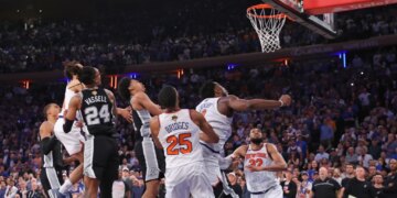 New York Knicks forward OG Anunoby #8 falls to the floor after scoring the game-winning basket as New York Knicks center Karl-Anthony Towns #32 watches the ball go through the net during game 4 of the 2026 NBA Finals against the San Antonio Spurs at Madison Square Garden.