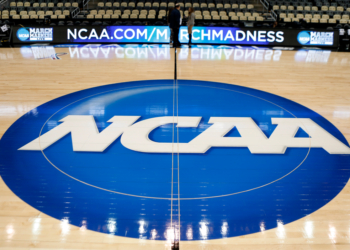 NCAA logo painted on a basketball court.
