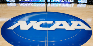 NCAA logo painted on a basketball court.
