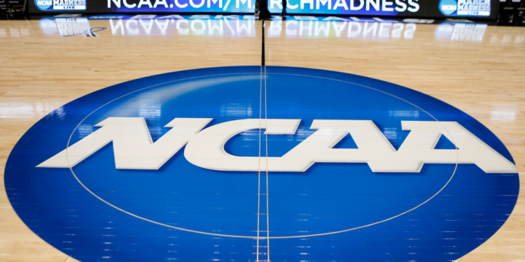NCAA logo painted on a basketball court.
