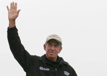 NASCAR legend Ned Jarrett waving to fans.