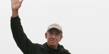 NASCAR legend Ned Jarrett waving to fans.