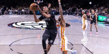 Brooklyn Nets forward Ziaire Williams shoots the ball over Atlanta Hawks guard Nickeil Alexander-Walker.